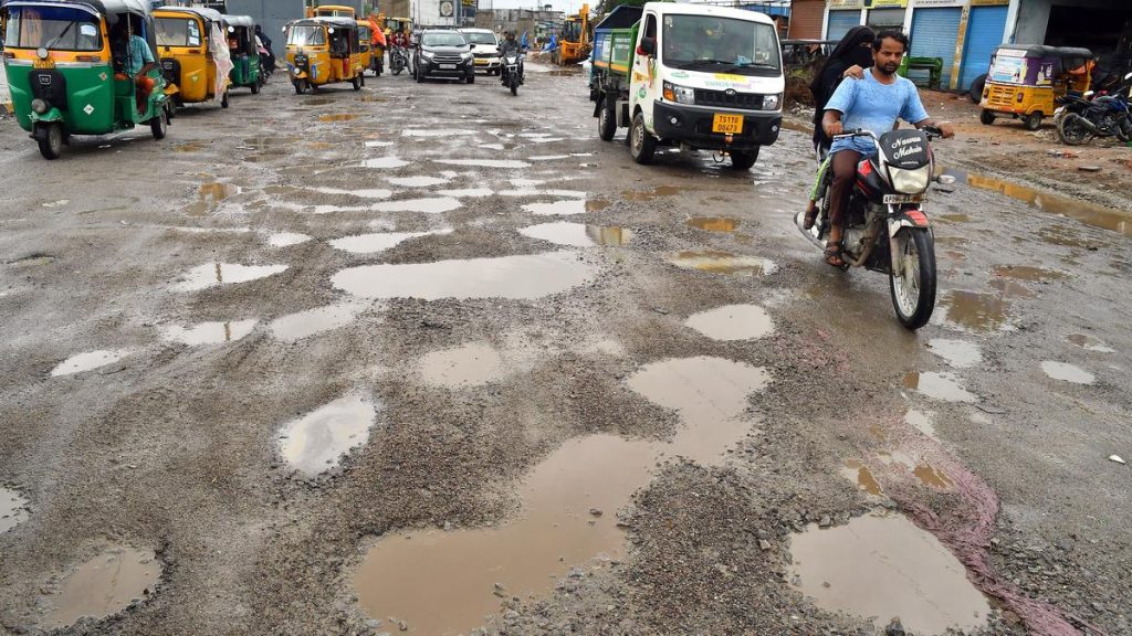 City Motorists and Pedestrians Grapple with Pothole Woes After Rain